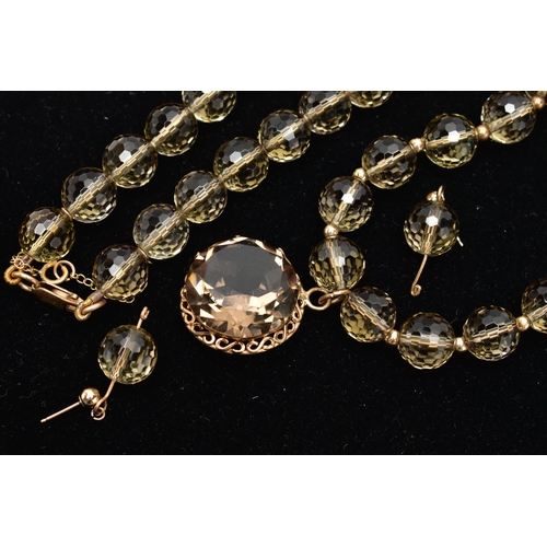 26 - A SMOKY QUARTZ BEADED NECKLACE AND MATCHING EARRINGS, the necklace made up of thirty-eight faceted r... 