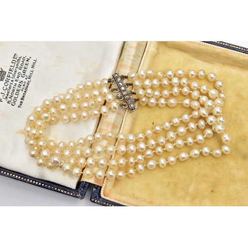 27 - A CULTURED FRESH WATER PEARL BRACELET WITH DIAMOND SET CLASP, a four row cultured pearl bracelet, ea... 