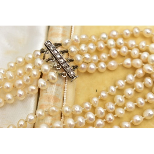 27 - A CULTURED FRESH WATER PEARL BRACELET WITH DIAMOND SET CLASP, a four row cultured pearl bracelet, ea... 