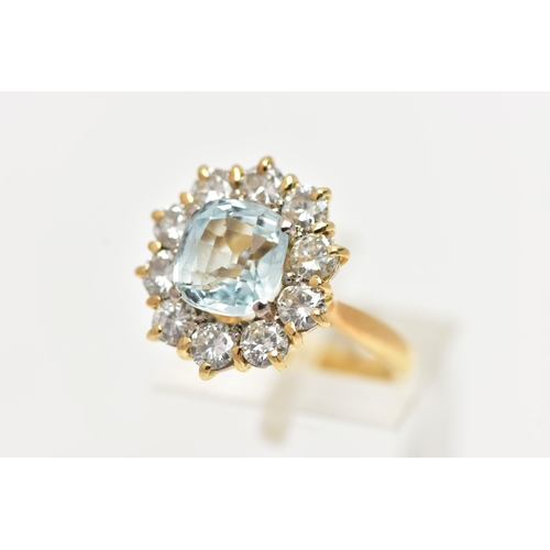 4 - A YELLOW METAL AQUAMARINE AND DIAMOND CLUSTER RING, centring on a four claw set, cushion cut aquamar... 