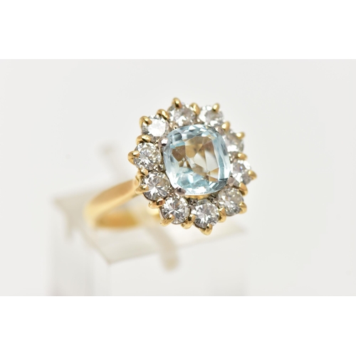 4 - A YELLOW METAL AQUAMARINE AND DIAMOND CLUSTER RING, centring on a four claw set, cushion cut aquamar... 