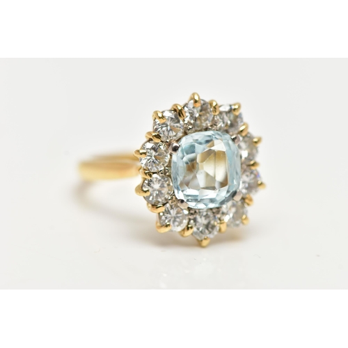 4 - A YELLOW METAL AQUAMARINE AND DIAMOND CLUSTER RING, centring on a four claw set, cushion cut aquamar... 