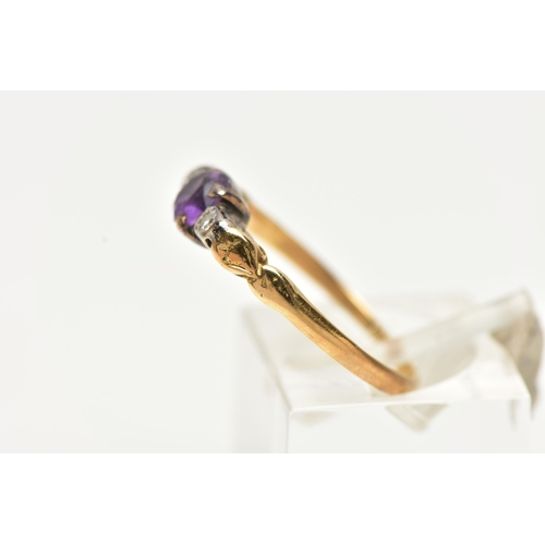 48 - A YELLOW METAL AMETHYST AND DIAMOND RING, centring on a claw set, circular cut amethyst, flanked wit... 