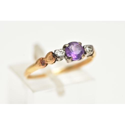 48 - A YELLOW METAL AMETHYST AND DIAMOND RING, centring on a claw set, circular cut amethyst, flanked wit... 