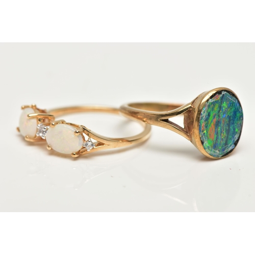 49 - TWO OPAL RINGS, the first designed with two claw set, oval cut opal cabochons, interspaced with roun... 