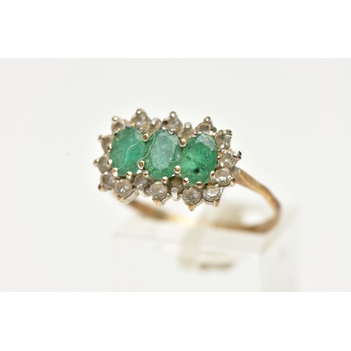 51 - A 9CT GOLD, EMERALD AND DIAMOND CLUSTER RING, designed with three claw set, oval cut emeralds, in a ... 