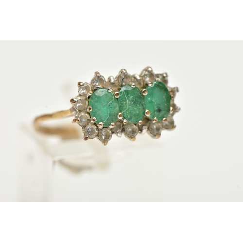 51 - A 9CT GOLD, EMERALD AND DIAMOND CLUSTER RING, designed with three claw set, oval cut emeralds, in a ... 