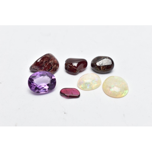 56 - A SMALL BAG OF ASSORTED LOOSE GEMSTONES, to include two white opal cabochons, both showing flashes a... 