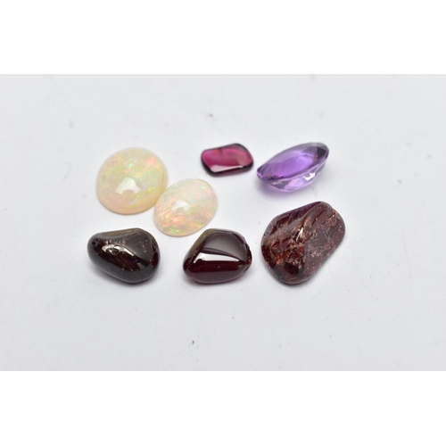 56 - A SMALL BAG OF ASSORTED LOOSE GEMSTONES, to include two white opal cabochons, both showing flashes a... 