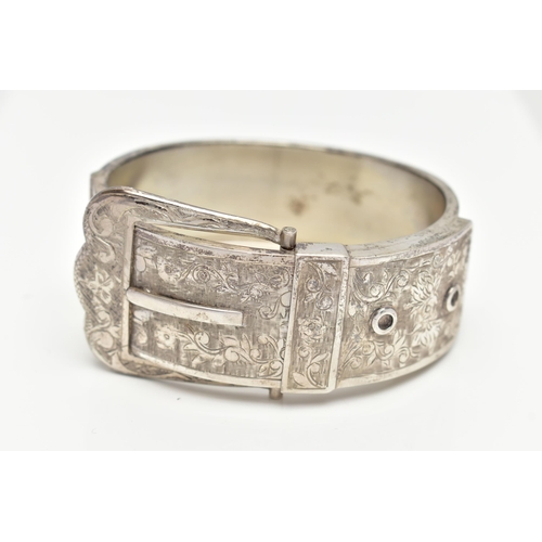 6 - A SILVER HINGED BANGLE, in the form of a belt and buckle, decorated with a floral pattern, hallmarke... 