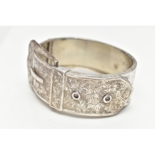 6 - A SILVER HINGED BANGLE, in the form of a belt and buckle, decorated with a floral pattern, hallmarke... 