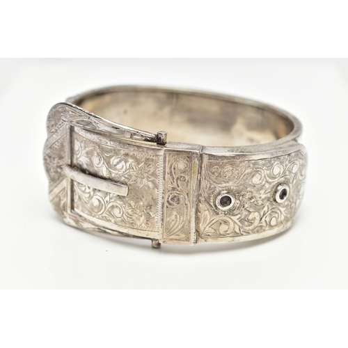 7 - A SILVER HINGED BANGLE, in the form of belt and buckle, decorated with a floral pattern, hallmarked ... 