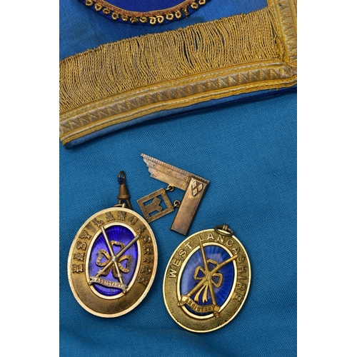 70 - A BOX OF MASONIC REGALIA, to include two silver gilt medallions, for the 'East and West Lancashire' ... 