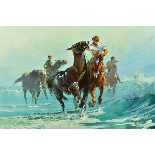 294 - JOHN HASKINS (BRITISH 1938) HORSES AND JOCKEYS EXERCISING SMALL BREAKING WAVES ON THE BEACH, signed ... 