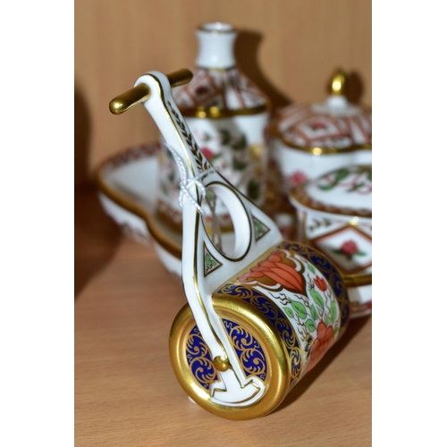 321 - A GROUP OF ROYAL CROWN DERBY, comprising a miniature garden roller, height 9.5cm, and watering can, ... 