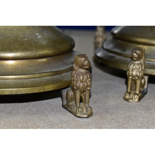 360 - A NEAR PAIR OF TALL BRASS CANDLESTICKS, with four feet in the form of lions, the central section app... 