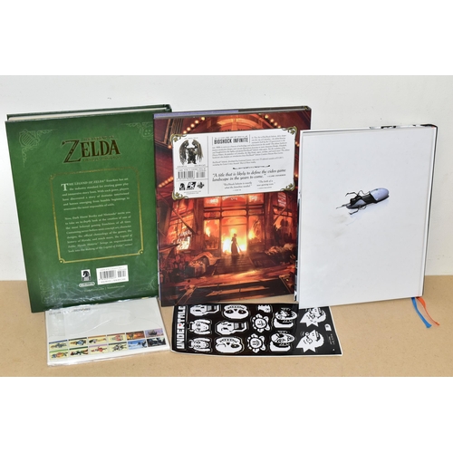 777 - THREE GAMING BOOKS, STICKERS AND POSTCARDS, includes the Portal 2 Collector's Reading Guide, The Art... 