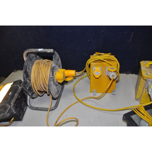 1091 - A 110V TRANSFORMER, a double extension reel, a 4 point extension cable, a 110v site light (all PAT p... 