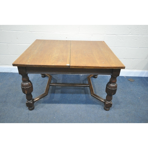 1218 - A 20TH CENTURY SOLID OAK DRAW LEAF TABLE, with a single fold out leaf, on block and acorn legs, unit... 