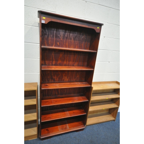 1234 - A TALL SLIM STAINED PINE OPEN BOOKCASE, with five fixed shelves, width 82cm x depth 28cm x height 18... 