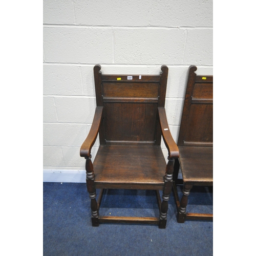 1241 - A SET OF FOUR LATE 20TH CENTURY OAK CHAIRS, including one carver, with panelled backs, on block and ... 