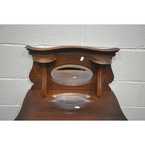 1242 - AN EDWARDIAN MAHOGANY MUSIC CABINET, with a raised mirrored back, above a single glazed door, on fro... 