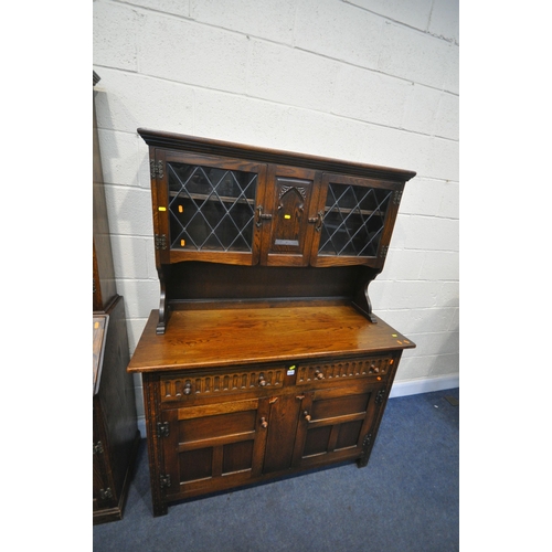 1255 - A 20TH CENTURY OAK DRESSER, the top with two lead glazed doors, base with two drawers over two cupbo... 