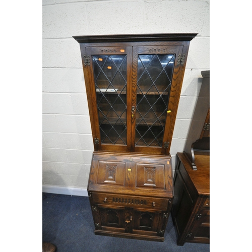 1255 - A 20TH CENTURY OAK DRESSER, the top with two lead glazed doors, base with two drawers over two cupbo... 