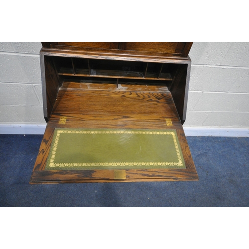 1255 - A 20TH CENTURY OAK DRESSER, the top with two lead glazed doors, base with two drawers over two cupbo... 