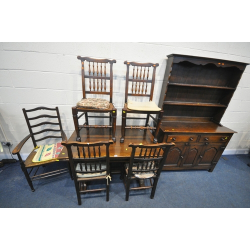 1257 - A 20TH CENTURY OAK DINING SUITE, comprising a draw leaf dining table, on twin acorn supports, extend... 