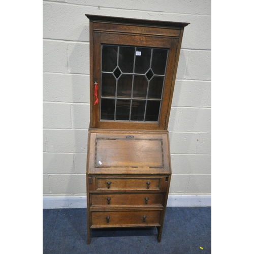 1275 - A 20TH CENTURY OAK BUREAU BOOKCASE, the top with a single lead glazed door, enclosing two adjustable... 