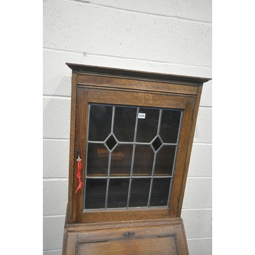 1275 - A 20TH CENTURY OAK BUREAU BOOKCASE, the top with a single lead glazed door, enclosing two adjustable... 