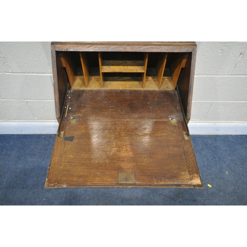 1275 - A 20TH CENTURY OAK BUREAU BOOKCASE, the top with a single lead glazed door, enclosing two adjustable... 