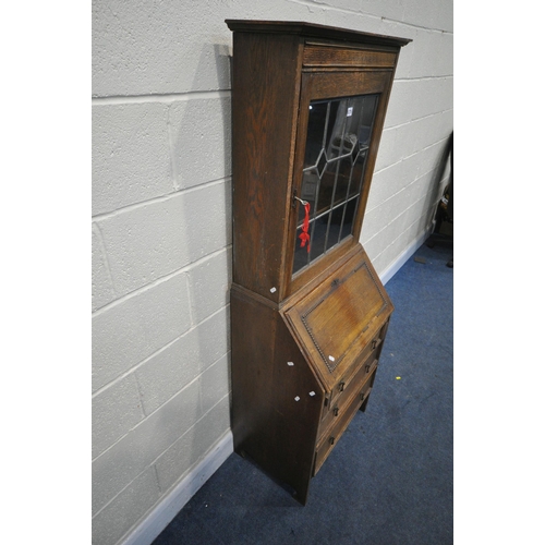 1275 - A 20TH CENTURY OAK BUREAU BOOKCASE, the top with a single lead glazed door, enclosing two adjustable... 