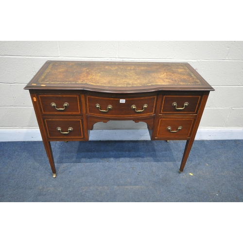 1277 - AN EDWARDIAN MAHOGANY AND INLAID BOW FRONT DESK, with a distressed leather writing surface, five dra... 