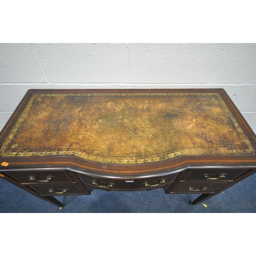 1277 - AN EDWARDIAN MAHOGANY AND INLAID BOW FRONT DESK, with a distressed leather writing surface, five dra... 