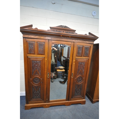 1280 - AN EDWARDIAN WALNUT TRIPLE DOOR COMPACTUM WARDROBE, with an overhanging cornice with foliate carving... 