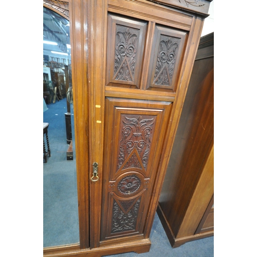 1280 - AN EDWARDIAN WALNUT TRIPLE DOOR COMPACTUM WARDROBE, with an overhanging cornice with foliate carving... 