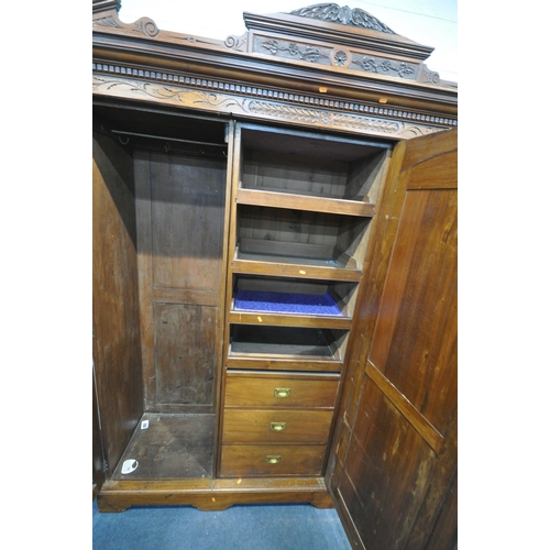 1280 - AN EDWARDIAN WALNUT TRIPLE DOOR COMPACTUM WARDROBE, with an overhanging cornice with foliate carving... 