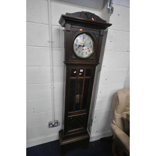 1283 - AN EARLY 20TH CENTURY OAK CHIMING LONGCASE CLOCK, with a brass and silvered dial, on a glazed trunk,... 