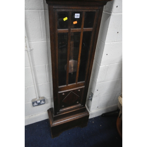 1283 - AN EARLY 20TH CENTURY OAK CHIMING LONGCASE CLOCK, with a brass and silvered dial, on a glazed trunk,... 