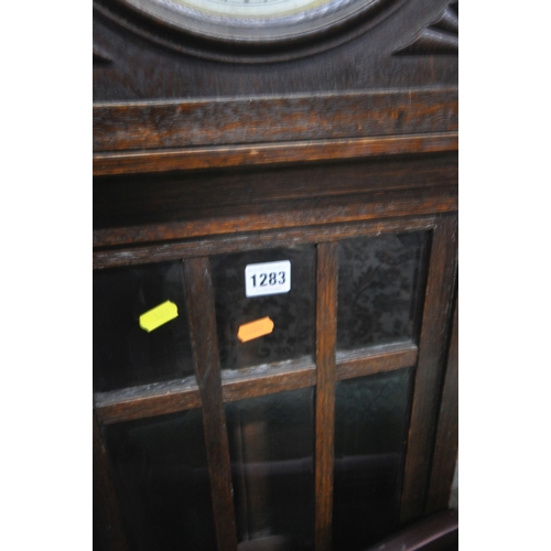 1283 - AN EARLY 20TH CENTURY OAK CHIMING LONGCASE CLOCK, with a brass and silvered dial, on a glazed trunk,... 