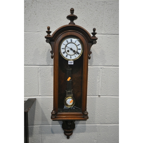 1287 - A LATE 19TH CENTURY WALNUT WALL CLOCK, with finials to case, brass and enamel dial, with roman numer... 