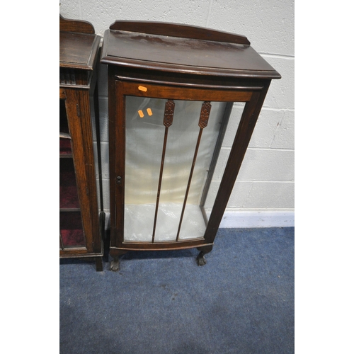 1296 - A 20TH CENTURY OAK SINGLE DOOR DISPLAY CABINET, with a raised back, the glazed door enclosing two sh... 