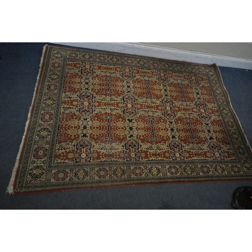 1307 - A TURKISH TABRIZ RUG, with a repeating geometric design, red field, an multi strap border, 235cm x 1... 