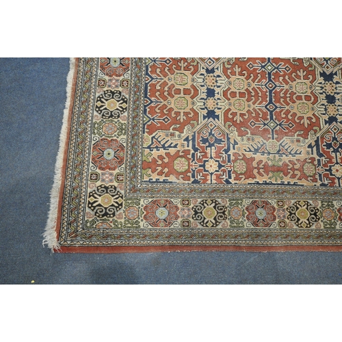 1307 - A TURKISH TABRIZ RUG, with a repeating geometric design, red field, an multi strap border, 235cm x 1... 