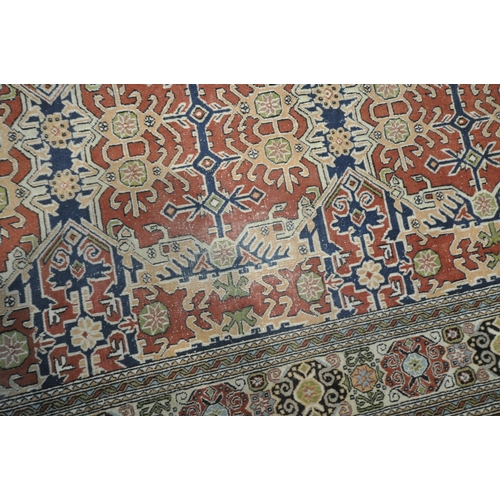 1307 - A TURKISH TABRIZ RUG, with a repeating geometric design, red field, an multi strap border, 235cm x 1... 