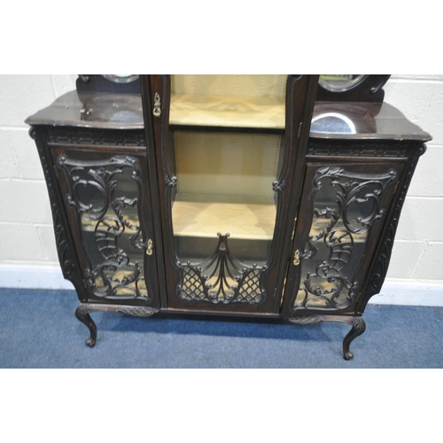 1309 - A LATE 19TH CENTURY MAHOGANY DISPLAY CABINET, with an arrangement of glazed doors, with foliate scro... 