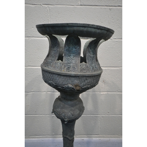 1314 - AN UNKNOWN BRONZE ORIENTAL ITEM, having a circular shaped top, on a separate shaped base with a myth... 