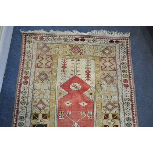 1326 - A PERSIAN MILAS RUG, cream and gold, and central red field, 190cm x 120cm (discolouration) and a Per... 